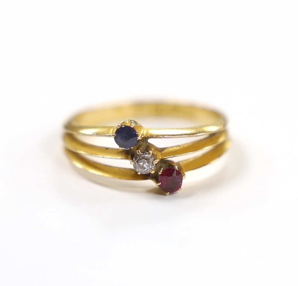 A late Victorian 18ct gold, sapphire ruby and diamond set three stone triple shank ring, size N, gross weight 2.9 grams.